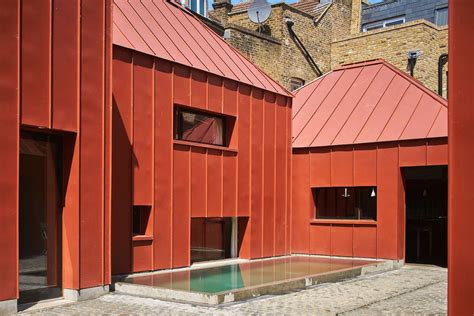 Red Tin House That Makes the Most of Space and Light